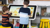 Children playing game on touchscreen table