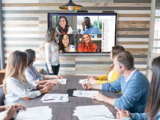 Group of colleagues on Teams call in meeting room