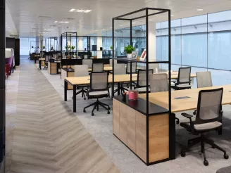 Open plan office with desks, chairs and storage units