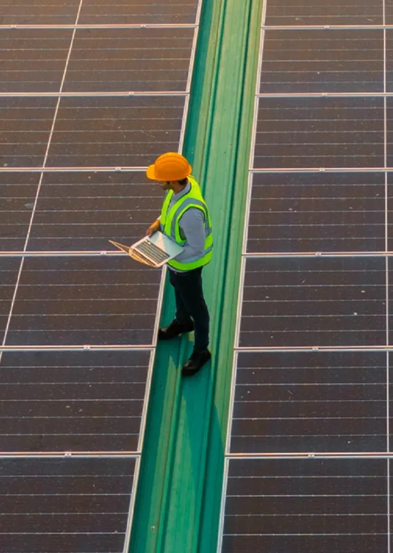 factory rooftop PV installation with man standing on it
