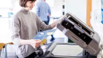Woman using colour photocopier