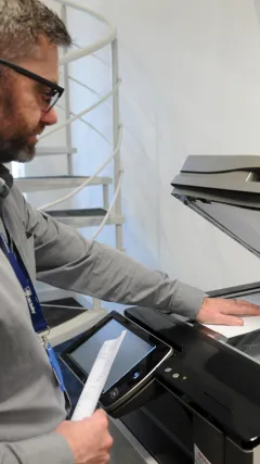 NG Bailey member of staff using a Sharp printer