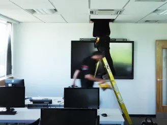 Engineers installing large screen