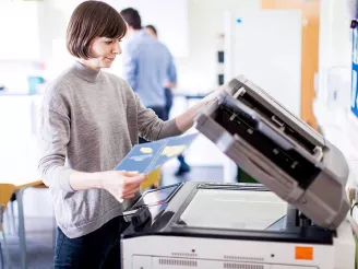 Woman using printer - print audit services
