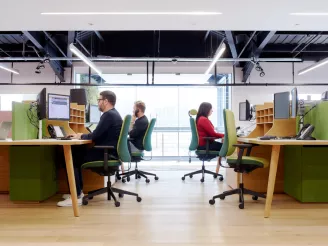 People sat at task chairs in office working