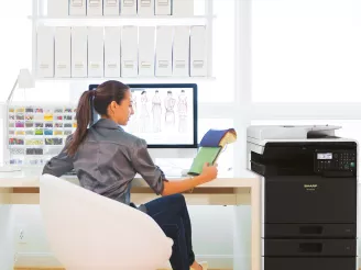 Designer working at desk with printer