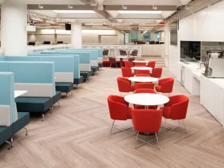 Office canteen with bench seating and tables and round tables and chairs