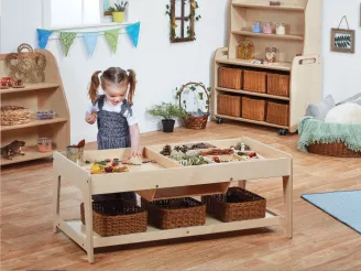 Girl playing with sensory toys a at nursery play table 