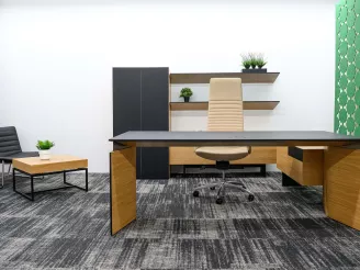 Modern small office with yellow desk, black task chair and grey carpet