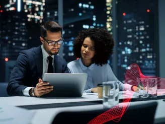 Business people in a modern office reviewing data on a tablet