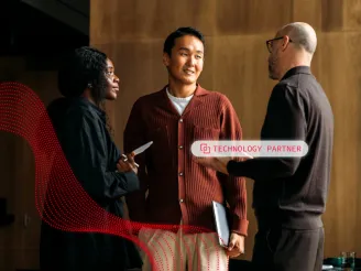 Three people stood talking with text saying 'Technology Partner' overlay