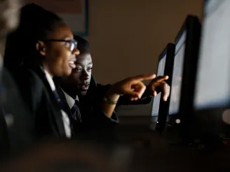 Two school children on a computer