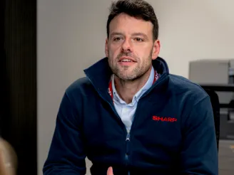 Person wearing a Sharp fleece providing support