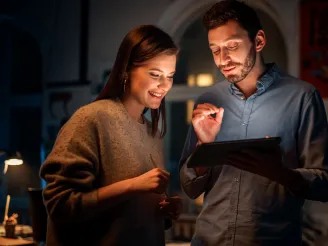 Two people looking at a tablet