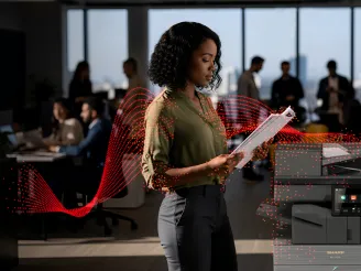 Woman reading papers by a Sharp A3 MFP