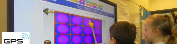 Children using an interactive whiteboard in a classroom