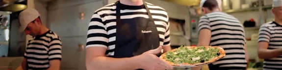 PizzaExpress chef holding a pizza