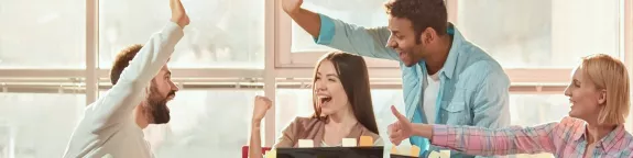 Team cheering in a meeting