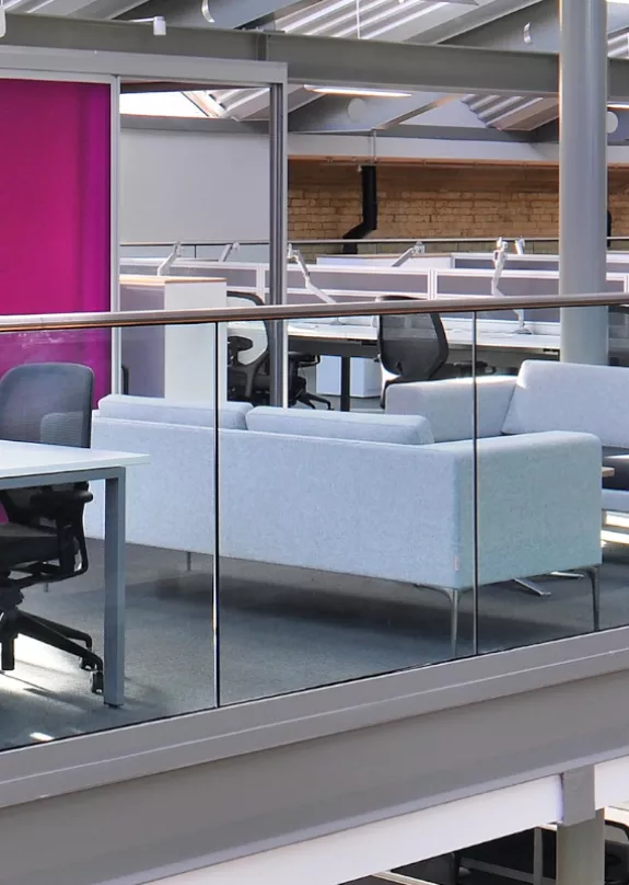 Banks of office desks and chairs in a open plan mezzanine in corporate office