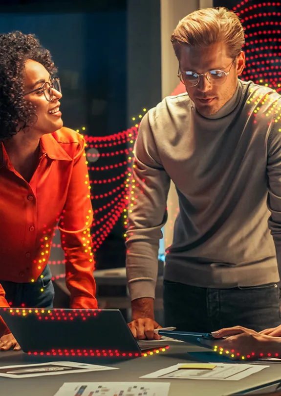 Three people having a meeting around a laptop 