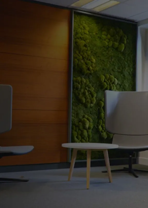 spacious open plan office with faux green wall