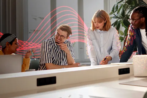 A group of colleauges working, with Sharp's Pulse in the background