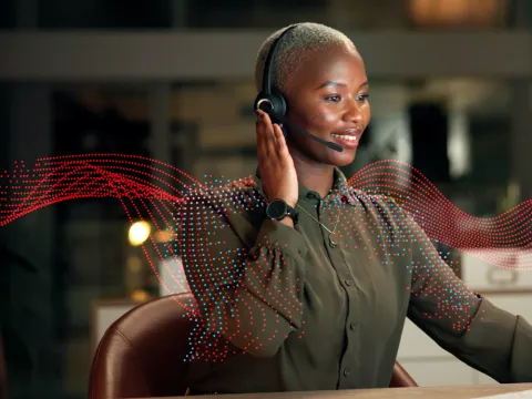 Helpdesk agent taking a phone call on her headset